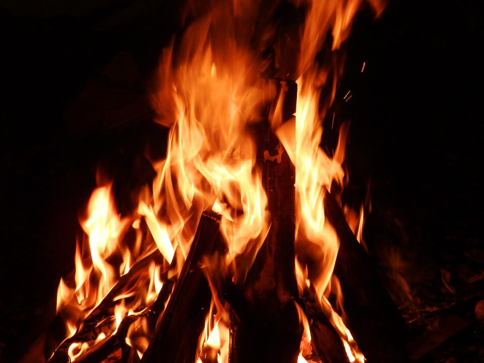 A picture of a fire burning inside a furnace