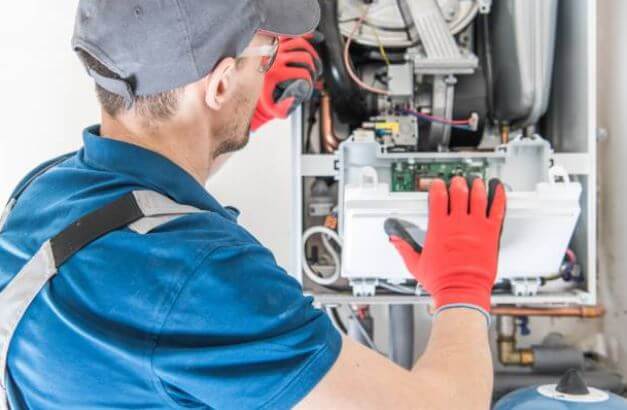 A technician repairing a furnace in Saratoga, CA