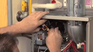 A technician repairing a furnace