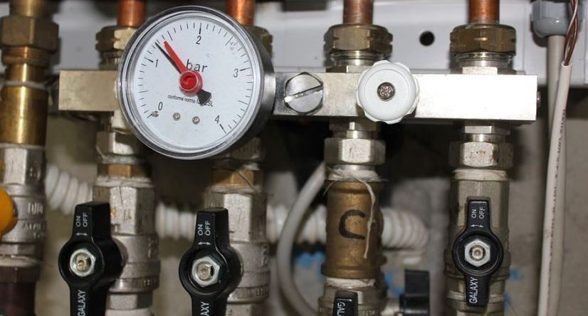 A close up image of a boiler's pressure gauge